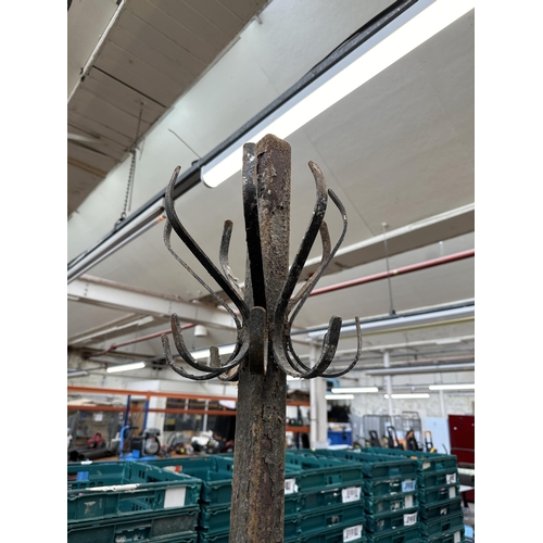 971 - A wrought iron coat rack - approx. 200cm high