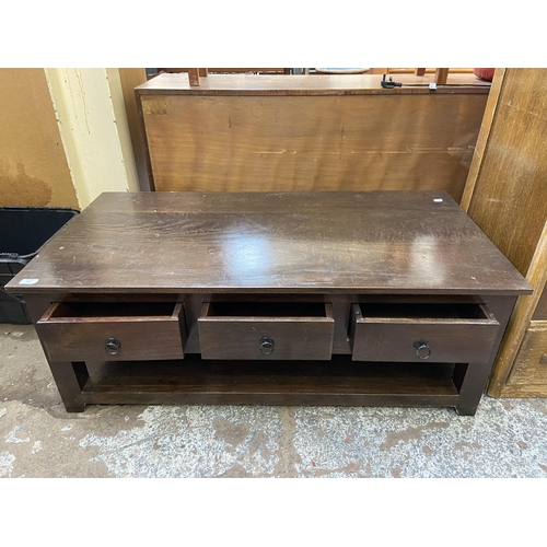 110 - A modern hardwood rectangular six drawer coffee table - approx. 45cm high x 61cm wide x 120cm long