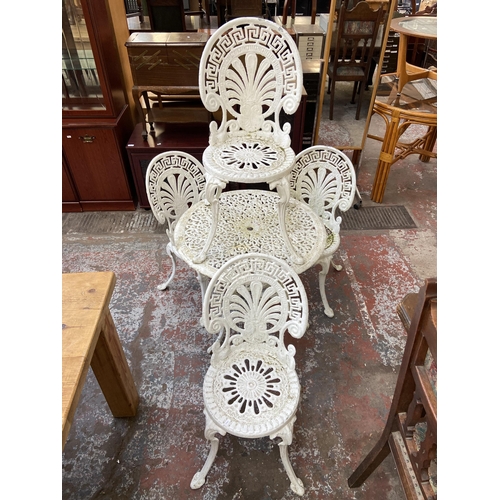 119 - A Victorian style white painted cast metal five piece patio set comprising circular table and four c... 