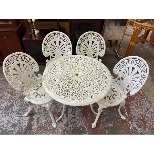 119 - A Victorian style white painted cast metal five piece patio set comprising circular table and four c... 