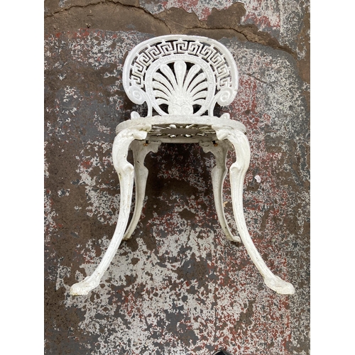 119 - A Victorian style white painted cast metal five piece patio set comprising circular table and four c... 