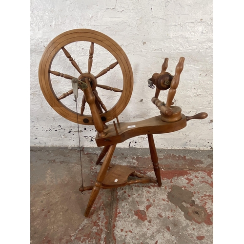 123 - A 19th century style beech spinning wheel - approx. 80cm high