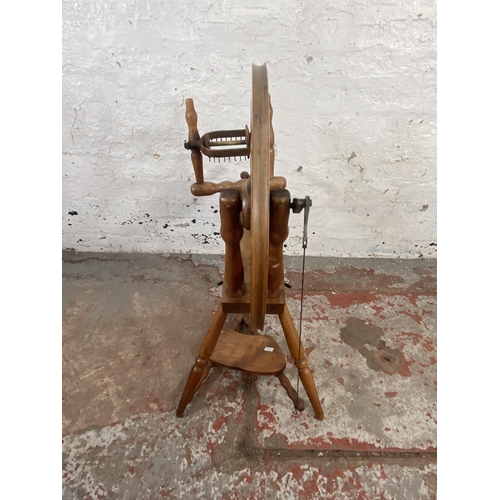 123 - A 19th century style beech spinning wheel - approx. 80cm high