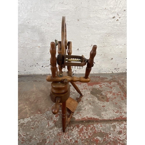 123 - A 19th century style beech spinning wheel - approx. 80cm high