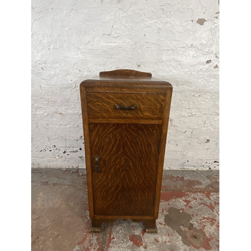 125 - An Art Deco oak bedside cabinet - approx. 74cm high x 34cm wide x 33cm deep