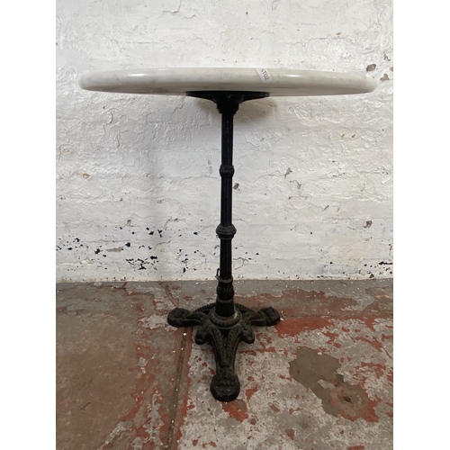 128 - A Victorian cast iron tripod pedestal pub table with later added marble circular top - approx. 73cm ... 