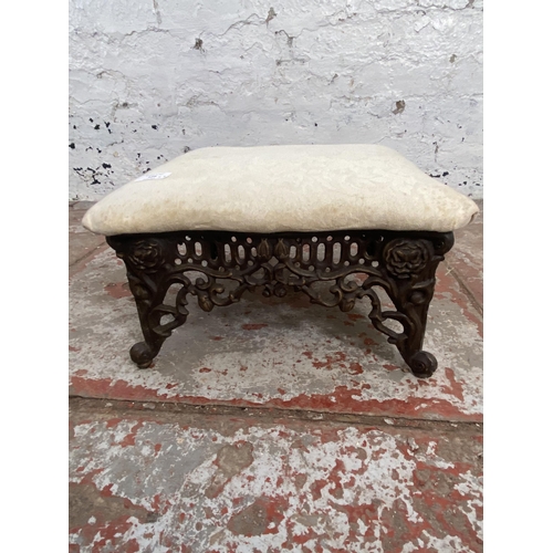 129 - Two stools, one Victorian style cast metal and floral fabric upholstered and one Lloyd Loom