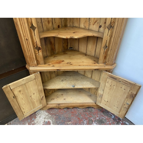 131 - A 19th century style pine free standing corner cabinet - approx. 198cm high