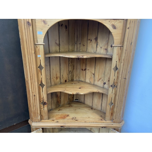 131 - A 19th century style pine free standing corner cabinet - approx. 198cm high