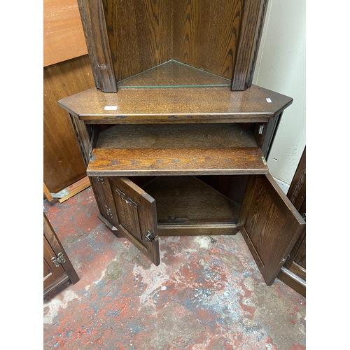 136 - A Jaycee carved oak free standing corner cabinet - approx. 200cm high