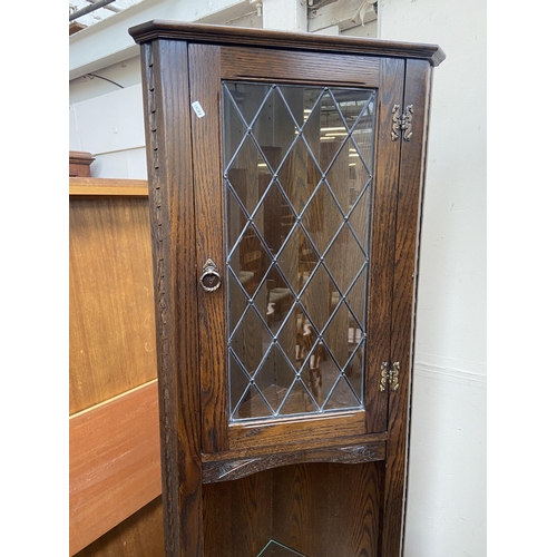 136 - A Jaycee carved oak free standing corner cabinet - approx. 200cm high