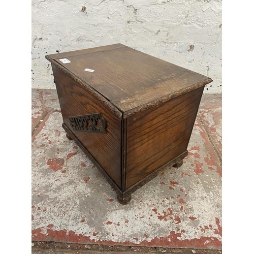 148 - An early/mid 20th century carved oak slipper box - approx. 33cm high x 40cm wide x 28cm deep