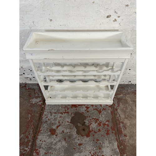 150 - A modern white painted twenty four section bottle rack - approx. 70cm high x 70cm wide x 23cm deep