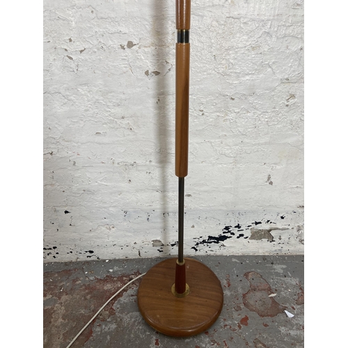 157 - A mid 20th century teak and brass standard lamp with circular base - approx. 141cm high