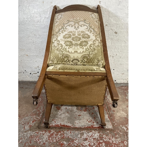 167 - An Arts & Crafts carved oak and floral fabric upholstered parlour armchair - approx. 115cm high x 65... 