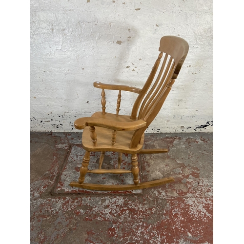 168 - A Victorian style beech farmhouse rocking chair