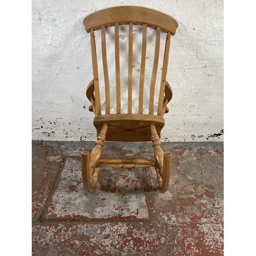 168 - A Victorian style beech farmhouse rocking chair