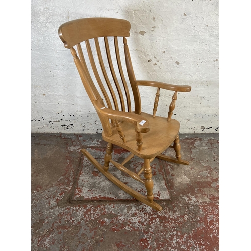 168 - A Victorian style beech farmhouse rocking chair