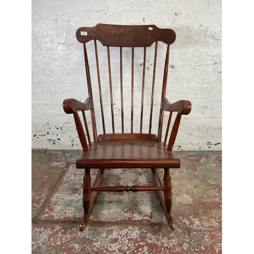 169 - A Victorian style stained beech farmhouse rocking chair