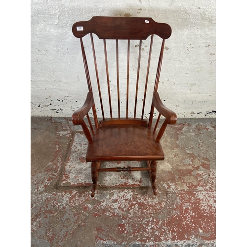 169 - A Victorian style stained beech farmhouse rocking chair