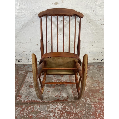 169 - A Victorian style stained beech farmhouse rocking chair