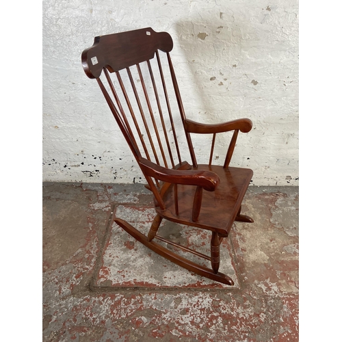 169 - A Victorian style stained beech farmhouse rocking chair