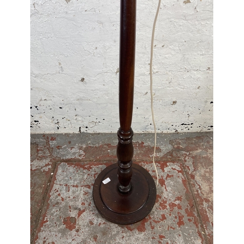 170A - A mahogany standard lamp with circular base - approx. 168cm high including shade