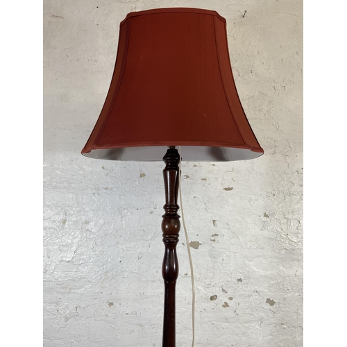 170A - A mahogany standard lamp with circular base - approx. 168cm high including shade