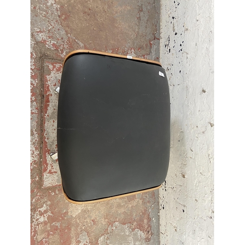 186 - A Charles & Ray Eames style black leather and bentwood revolving footstool - approx. 44cm high x 65c... 