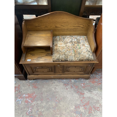 199 - A carved oak telephone table - approx. 77cm high x 85cm wide x 43cm deep