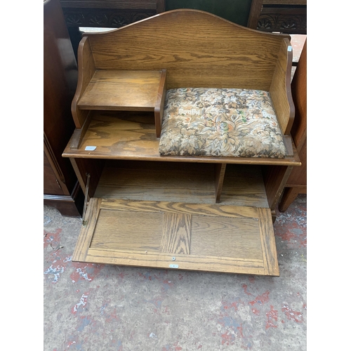 199 - A carved oak telephone table - approx. 77cm high x 85cm wide x 43cm deep