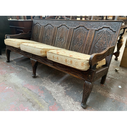 207 - An 18th century carved oak settle - approx. 81cm high x 183cm wide x 73cm deep