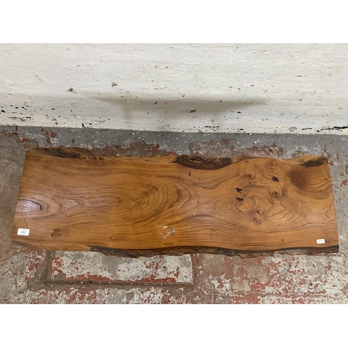 209 - A mid 20th century elm tree slice coffee table on dansette supports - approx. 48cm high x 46cm wide ... 