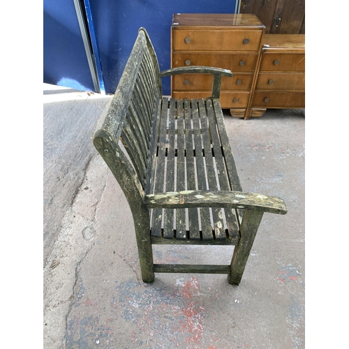 217 - A teak two seater garden bench - approx. 96cm high x 139cm wide x 51cm deep