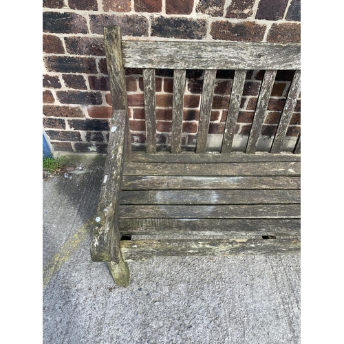 220 - A teak three seater garden bench - approx. 92cm high x 184cm wide x 64cm deep