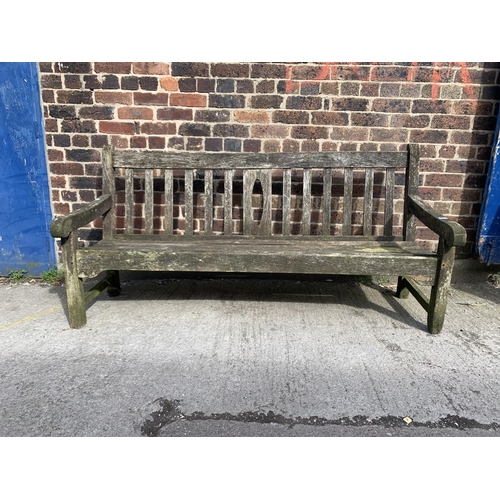 220 - A teak three seater garden bench - approx. 92cm high x 184cm wide x 64cm deep