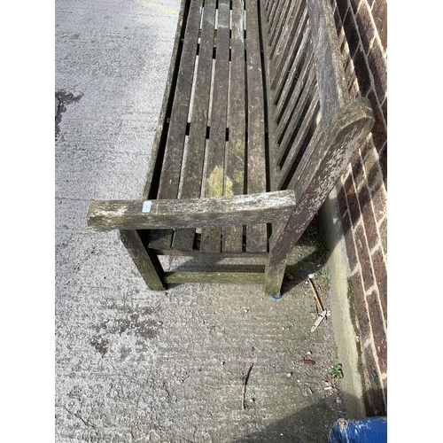 220 - A teak three seater garden bench - approx. 92cm high x 184cm wide x 64cm deep