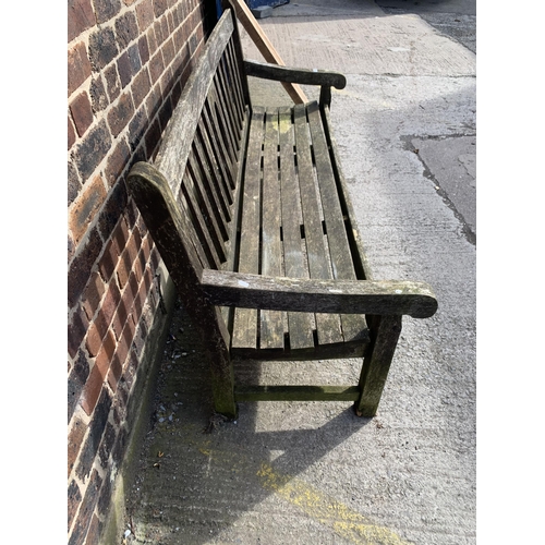 220 - A teak three seater garden bench - approx. 92cm high x 184cm wide x 64cm deep