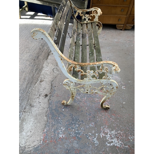 221 - A Victorian style cast iron and wooden slatted garden bench - approx. 83cm high x 126cm wide x 79cm ... 