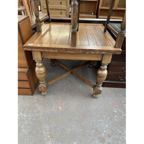 223 - A 1930s oak draw leaf dining table and four chairs - table approx. 75cm high x 91cm wide x 87cm long... 