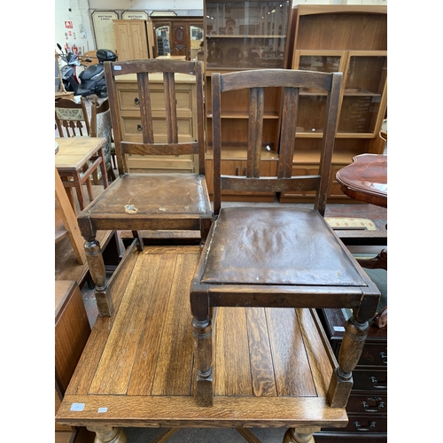 223 - A 1930s oak draw leaf dining table and four chairs - table approx. 75cm high x 91cm wide x 87cm long... 