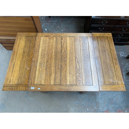 223 - A 1930s oak draw leaf dining table and four chairs - table approx. 75cm high x 91cm wide x 87cm long... 