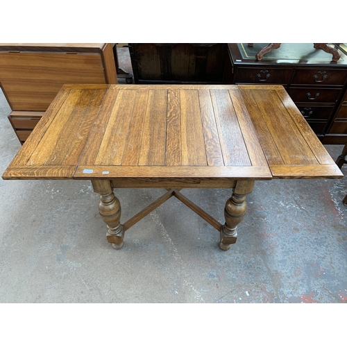 223 - A 1930s oak draw leaf dining table and four chairs - table approx. 75cm high x 91cm wide x 87cm long... 