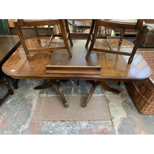 230 - A Georgian style mahogany twin pedestal extending ‘D’ end dining table and six shield back chairs - ... 