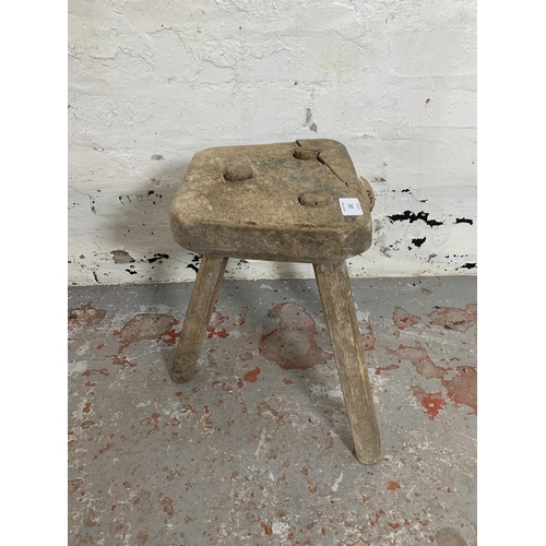 232 - A 19th century rustic elm and beech tripod farmhouse stool - approx. 38cm high x 25cm wide x 22cm de... 