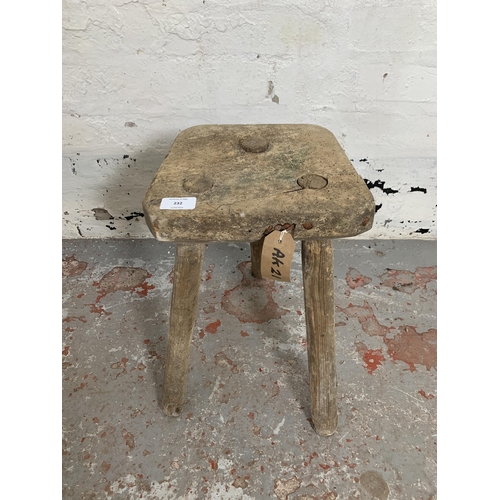 232 - A 19th century rustic elm and beech tripod farmhouse stool - approx. 38cm high x 25cm wide x 22cm de... 