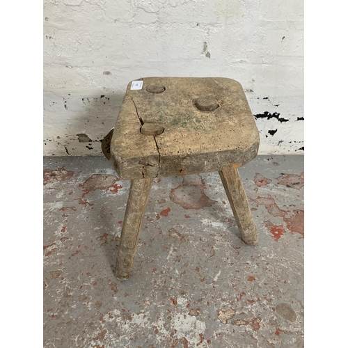 232 - A 19th century rustic elm and beech tripod farmhouse stool - approx. 38cm high x 25cm wide x 22cm de... 