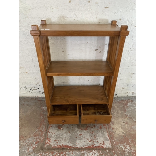 243 - A modern teak two tier bookcase with two lower drawers - approx. 113cm high x 83cm wide x 39cm deep