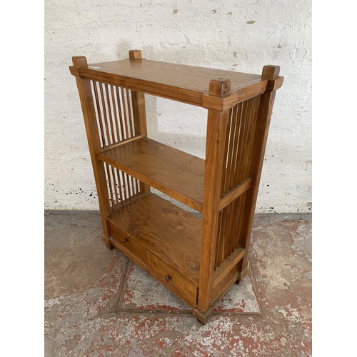 243 - A modern teak two tier bookcase with two lower drawers - approx. 113cm high x 83cm wide x 39cm deep