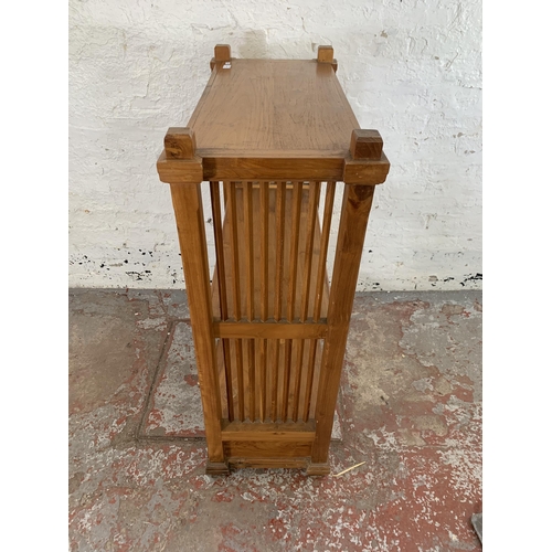 243 - A modern teak two tier bookcase with two lower drawers - approx. 113cm high x 83cm wide x 39cm deep